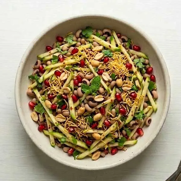 Raw mango and black eye bean salad with pomegranate, peanut and sev